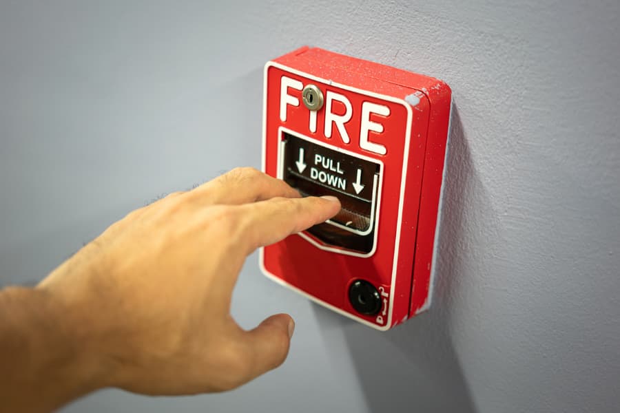 Closeup of person pulling fire alarm