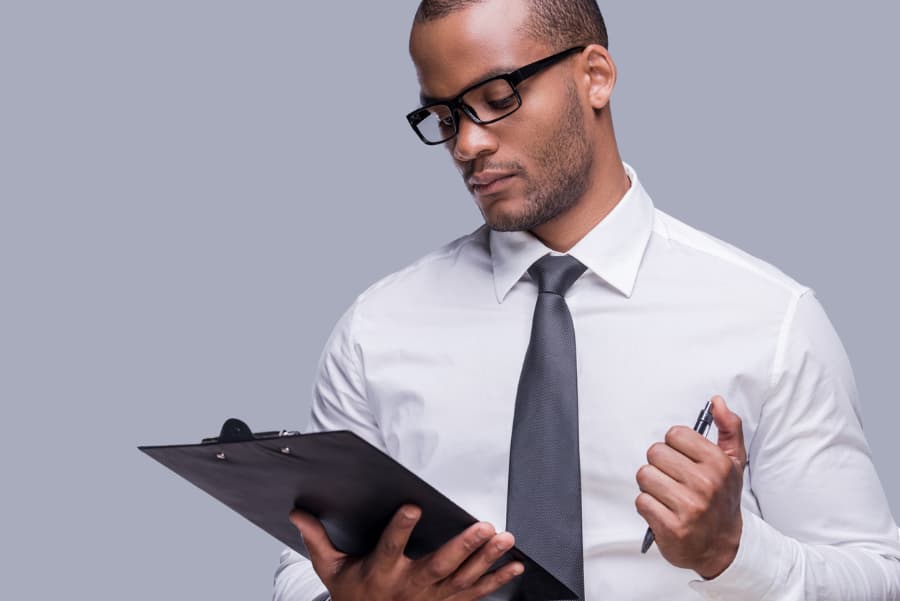 Man checking list on clipboard