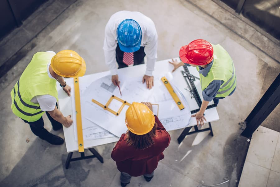 Workers going over plans for commercial restoration project