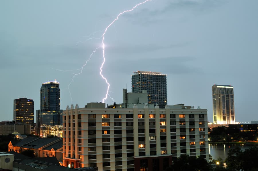 Lightning hitting across industrial skyline