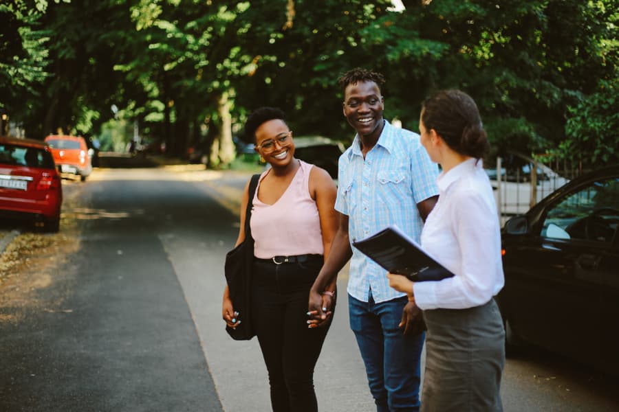 Young couple meeting with real estate agent looking for apartment to buy